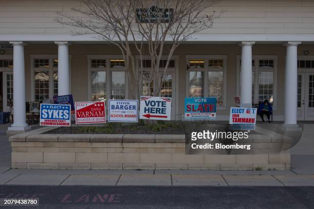 Campaign signs outside an early voting location in Southport, North Carolina, US, on Thursday, Feb. 22, 2024. Democrats are targeting small towns in...