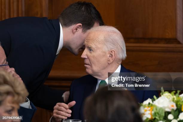 Jacob Spreyer, personal aide to U.S. President Joe Biden, speaks privately to the president during the annual Friends Of Ireland Speaker Luncheon at...