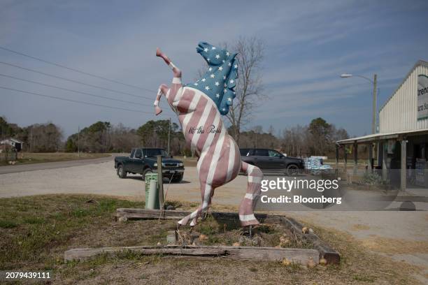 Horse sculpture painted in the colors of the American flag in Southport, North Carolina, US, on Thursday, Feb. 22, 2024. Democrats are targeting...