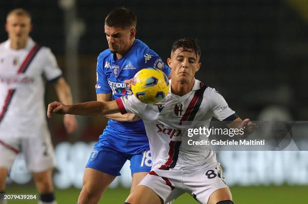 Kacper Urbanski of Bologna FC in action against Ravzan Gabriel Marin of Empoli FC during the Serie A TIM match between Empoli FC and Bologna FC at...