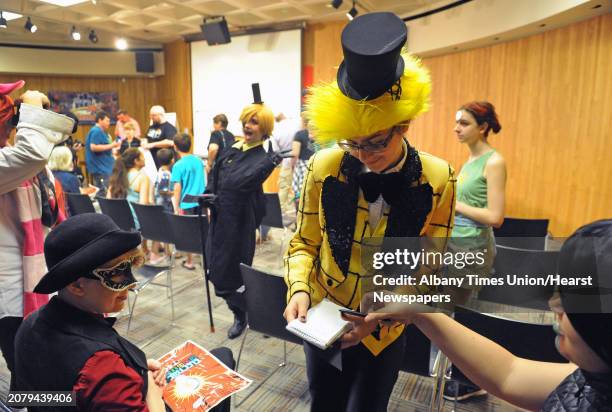 Alexis Deyette, center, of Scotia dressed as Gravity Falls character Bill Cipher and friends attend the Schenectady Public Library Electric City...