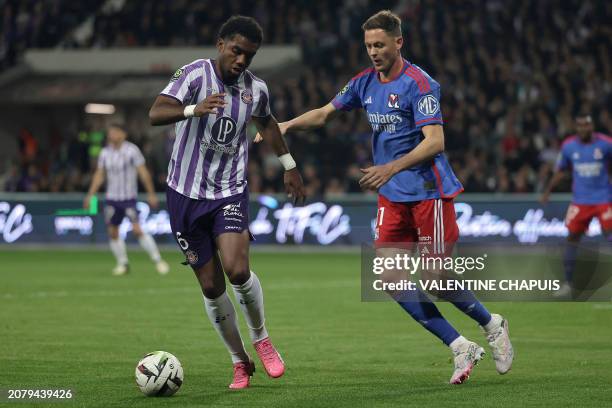 Toulouse's Cape Verdean defender Logan Costa and Lyon's Serbian Slovak midfielder Nemanja Matic fight for the ball during the French L1 football...