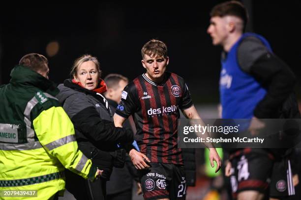 Dublin , Ireland - 15 March 2024; Cian Byrne of Bohemians leaves the pitch with Bohemians doctor Fiona Dennehy to receives medical attention during...