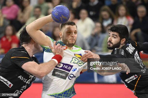 Slovenia's left back Aleks Vlah vies with Spain's pivot Abel Serdio Guntin and Spain's right back Imanol Garciandia Alustiza during the qualifying...