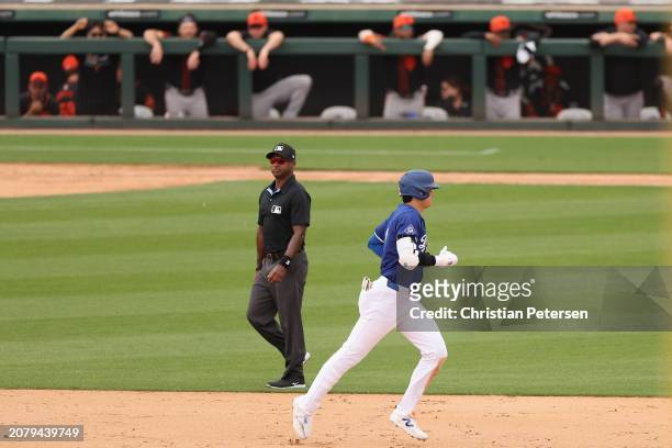 Shohei Ohtani of the Los Angeles Dodgers rounds the bases after hitting a two-run home run against the San Francisco Giants during the sixth inning...