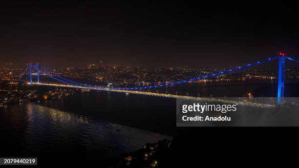 An aerial view of the Fatih Sultan Mehmet Bridge, illuminated with blue lights to raise awareness for colon cancer in Istanbul, Turkiye on March 15,...