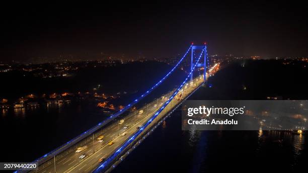 An aerial view of the Fatih Sultan Mehmet Bridge, illuminated with blue lights to raise awareness for colon cancer in Istanbul, Turkiye on March 15,...