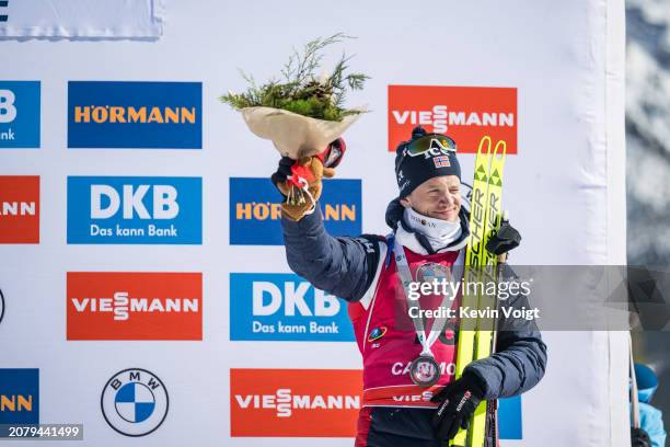 Tarjei Boe of Norway celebrates during the medal ceremony for placing third at the Men 10 km Sprint at the BMW IBU World Cup Biathlon on March 15,...