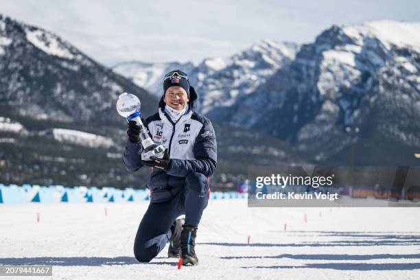 Tarjei Boe of Norway with the trophy for the sprint world cup score after the Men 10 km Sprint at the BMW IBU World Cup Biathlon on March 15, 2024 in...