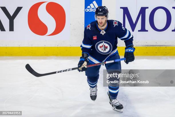 Colin Miller of the Winnipeg Jets skates during first period action against the Washington Capitals at Canada Life Centre on March 11, 2024 in...