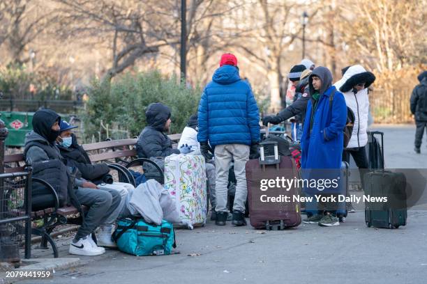 Migrants are pictured in Tompkins Square Park across from a migrant re-ticketing center at St. Brigid School on E. 7th St. Friday, Jan. 5 in...