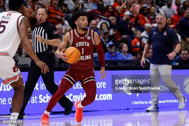 South Carolina Gamecocks guard Jacobi Wright dribbles in front of Auburn Tigers forward Chris Moore during a quarterfinal round game of the men's...