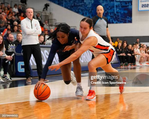 Pennsylvania Quakers Guard Simone Sawyer and Princeton Tigers Guard Skye Belker chase a loose ball during the second half of the Women's Ivy League...