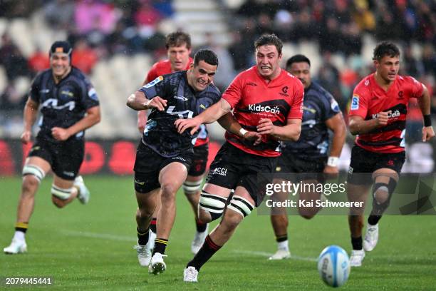 Josh Moorby of the Hurricanes and Dominic Gardiner of the Crusaders compete for the ball during the round four Super Rugby Pacific match between the...