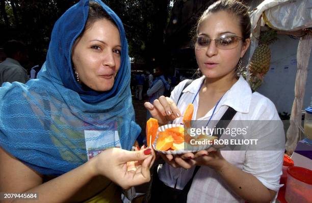 Brazilian delegates Veronica de Souza and Klara Brasil eats some fruits at the 2004 World Social Forum , in Bombay, 20 January 2004. More than 100...