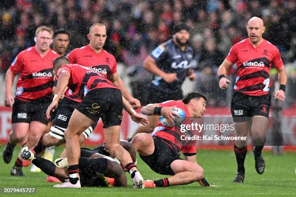 David Havili of the Crusaders is tackled during the round four Super Rugby Pacific match between the Crusaders and Hurricanes at Apollo Projects...