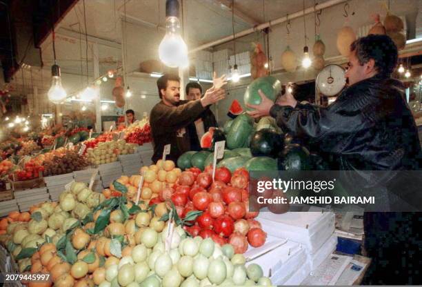 An Iranian buys a watermelon 21 December in Tehran ahead of celeberations of the ancient Zoroastrian feast of "Yalda" marking the longest night of...