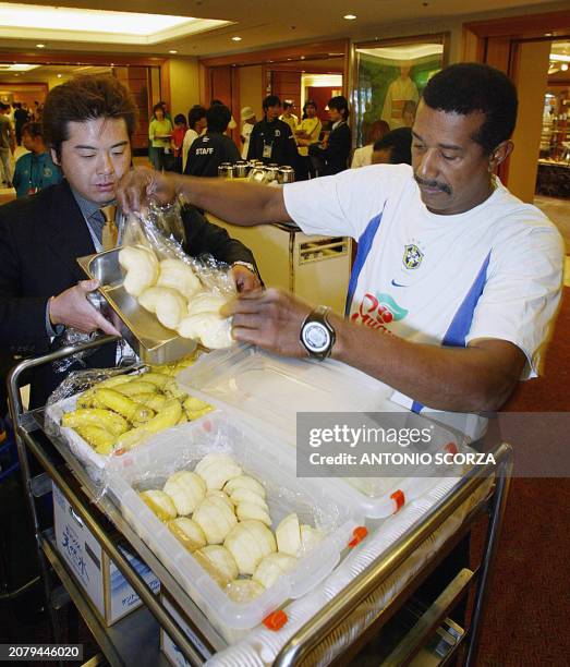 Brazilian assistant Jorge Jorginho checks the apple slices will be served to the players, 18 June 2002, at the Grand Hamamatsu hotel in Japan. Brazil...