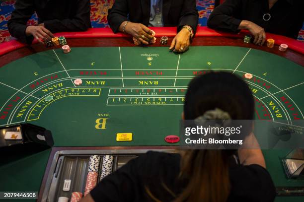 Players on a Baccarat Super 6 table inside Philippine Amusement and Gaming Corp.'s Casino Filipino Citystate, in Manila, the Philippines, on...
