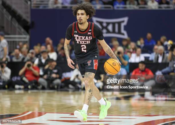 Texas Tech Red Raiders guard Pop Isaacs brings the ball up court in the first half of a Big 12 tournament semifinal game between the Texas Tech Red...