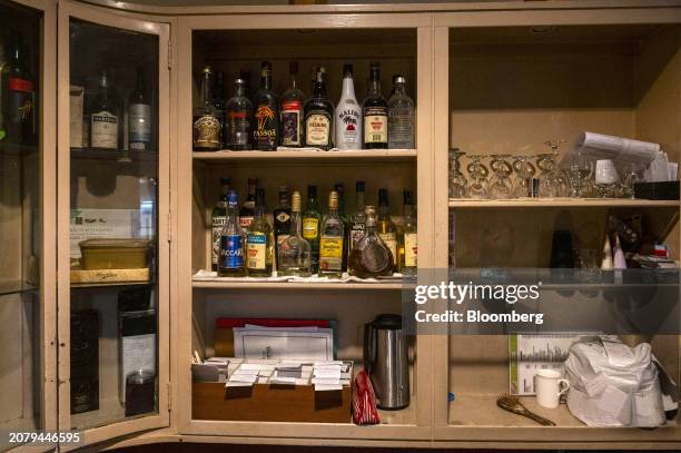 Bottles of alcohol in a cabinet at a bar inside Philippine Amusement and Gaming Corp.'s Casino Filipino Citystate, in Manila, the Philippines, on...