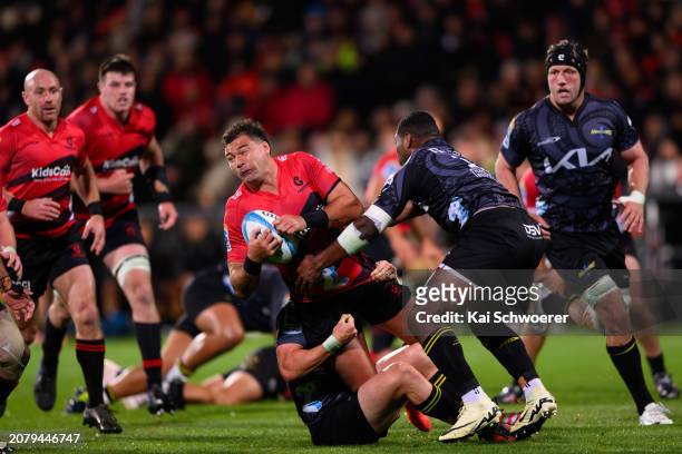 David Havili of the Crusaders is tackled during the round four Super Rugby Pacific match between the Crusaders and Hurricanes at Apollo Projects...