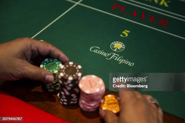 Signage for Casino Filipino on a Baccarat Super 6 table inside Philippine Amusement and Gaming Corp.'s casino in Manila, the Philippines, on...