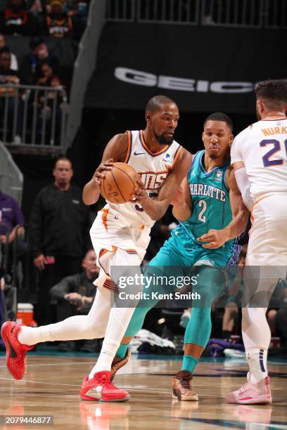 Kevin Durant of the Phoenix Suns handles the ball during the game against the Charlotte Hornets on March 15, 2024 at Spectrum Center in Charlotte,...