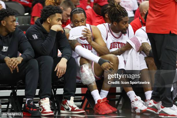 Houston Cougars forward J'Wan Roberts on the bench with ice around his kneed in the first half of a Big 12 tournament semifinal game between the...