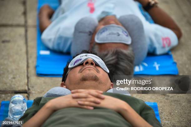 People enjoy a nap while attending the World Sleep Day event at the Monumento a la Revolución in Mexico City, Mexico, on March 15, 2024.