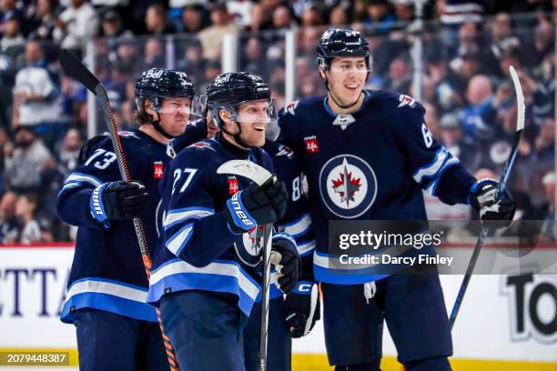 Tyler Toffoli, Nikolaj Ehlers and Logan Stanley of the Winnipeg Jets celebrate a third period goal against the Anaheim Ducks at the Canada Life...