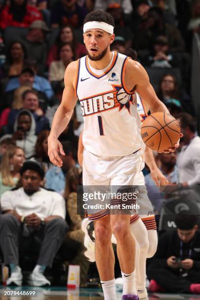 Devin Booker of the Phoenix Suns handles the ball during the game against the Charlotte Hornets on March 15, 2024 at Spectrum Center in Charlotte,...