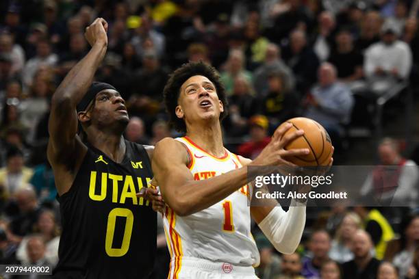 Jalen Johnson of the Atlanta Hawks shoots over Taylor Hendricks of the Utah Jazz during the first half of a game at Delta Center on March 15, 2024 in...