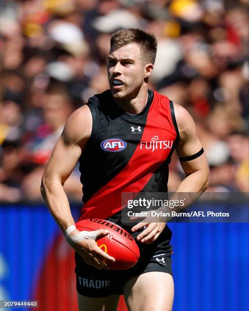 Zach Merrett of the Bombers in action during the 2024 AFL Round 01 match between the Essendon Bombers and the Hawthorn Hawks at the Melbourne Cricket...