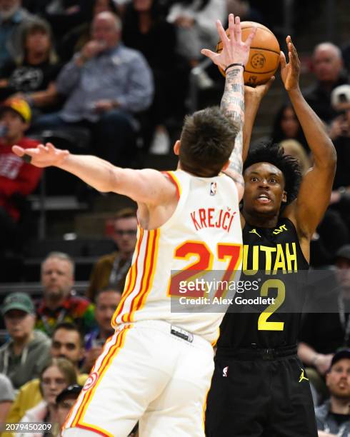 Collin Sexton of the Utah Jazz shoots over Vit Krejci of the Atlanta Hawks during the second half of a game at Delta Center on March 15, 2024 in Salt...