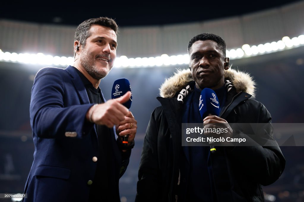 Julio Cesar (L) and Clarence Seedorf speak prior to the UEFA...