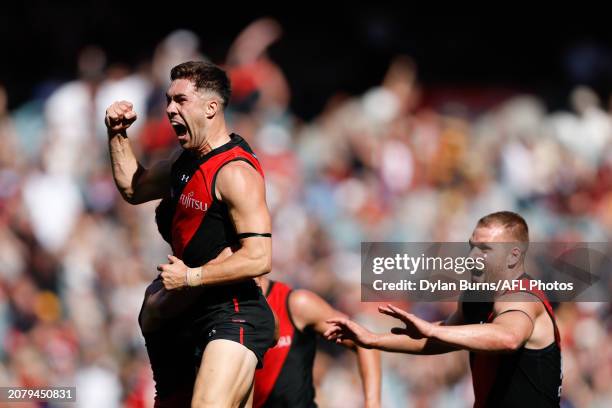 Jade Gresham of the Bombers celebrates a goal with teammates during the 2024 AFL Round 01 match between the Essendon Bombers and the Hawthorn Hawks...