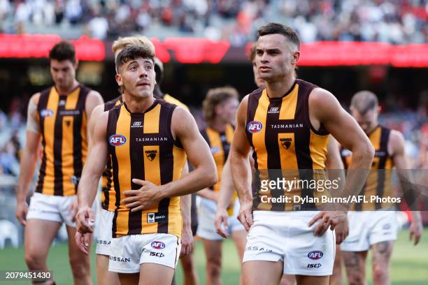 Karl Amon and Massimo D'Ambrosio of the Hawks look dejected after a loss during the 2024 AFL Round 01 match between the Essendon Bombers and the...