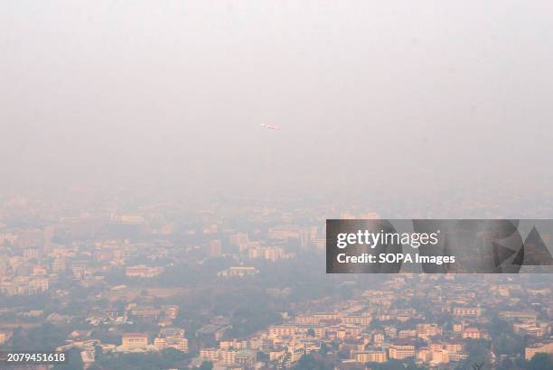 An Air Asia airlines' aircraft as it takes off from Chiang Mai International Airport amid smog caused by heavy concentrations of fine particulate...