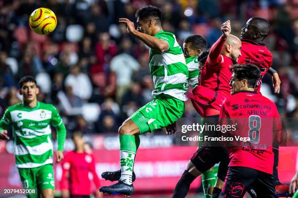 Santiago Núñez of Santos competes for the ball with Carlos Gonzalez and Kevin Balanta of Tijuana during the 12th round match between Tijuana and...