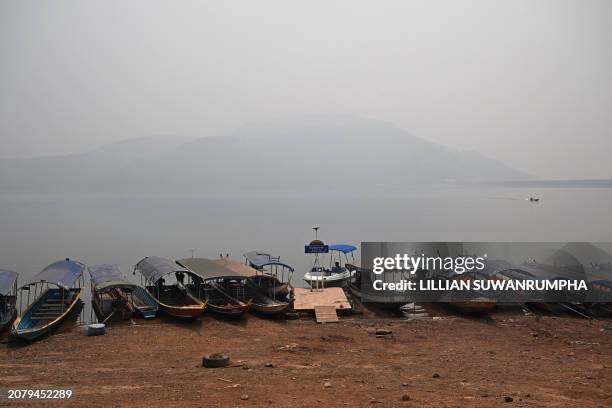 Boatman sits amid high air pollution at Srilanna National Park in the northern Thai province of Chiang Mai on March 16, 2024.