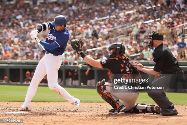 Shohei Ohtani of the Los Angeles Dodgers bats against the San Francisco Giants during the fifth inning of the MLB spring game at Camelback Ranch on...