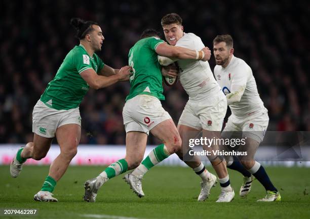 Of England is tackled by ROBBIE HENSHAW of Ireland during during the Guinness Six Nations 2024 match between England and Ireland at Twickenham...