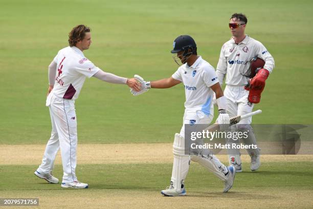 Oliver Davies of New South Wales shakes hands with Mitchell Swepson of Queensland during the Sheffield Shield match between Queensland and New South...