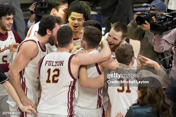The Charleston Cougars celebrate a win over the Stony Brook Seawolves in the CAA Men's Basketball Tournament against at the Entertainment & Sports...