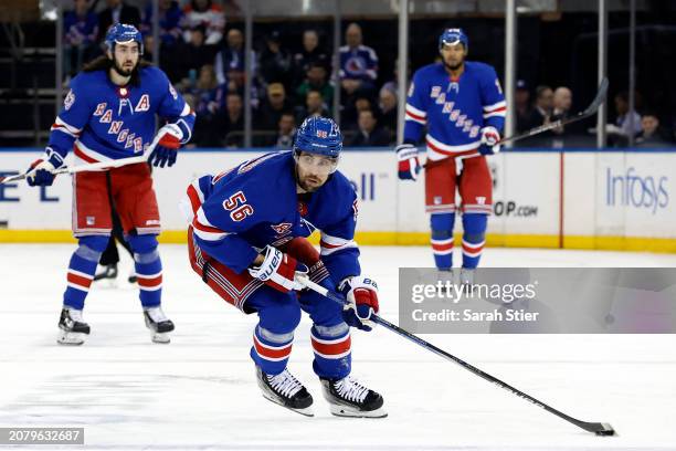 Erik Gustafsson of the New York Rangers controls the puck during the second period against the New Jersey Devils at Madison Square Garden on March...