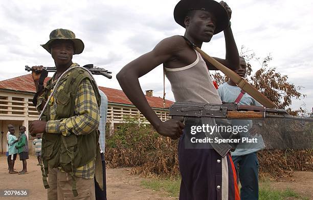 Members of the Union of the Congolese Patriots patrol the streets June 11, 2003 in Bunia, the provincial capital of Ituri province in the Democratic...