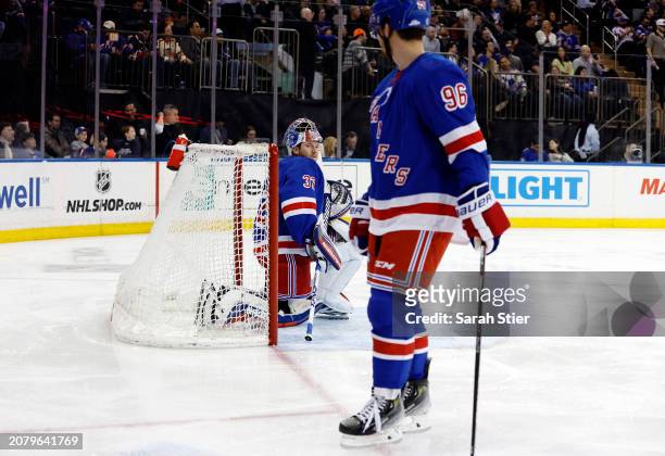 Jonathan Quick talks with Jack Roslovic of the New York Rangers during the first period against the New Jersey Devils at Madison Square Garden on...
