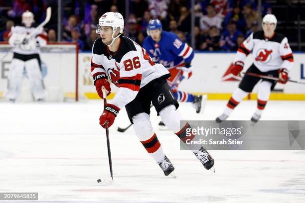 Jack Hughes of the New Jersey Devils controls the puck during the first period against the New York Rangers at Madison Square Garden on March 11,...
