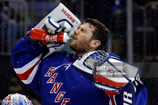 Jonathan Quick of the New York Rangers sprays water during the first period against the New Jersey Devils at Madison Square Garden on March 11, 2024...